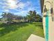 Landscaped backyard with mature trees offering shade and privacy, as well as view of home at 3215 Peace River Dr, Punta Gorda, FL 33983
