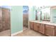 Tiled bathroom featuring dual showers, an arched window and spacious vanity with a white countertop at 3215 Peace River Dr, Punta Gorda, FL 33983