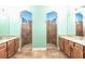 Luxury bathroom featuring dual vanities and two spacious walk-in showers at 3215 Peace River Dr, Punta Gorda, FL 33983