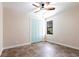 Tile floored bedroom with a window and bi-fold closet doors, and a ceiling fan at 3215 Peace River Dr, Punta Gorda, FL 33983
