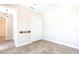 Bedroom featuring tile flooring, bi-fold closet doors, coat hooks, and natural light from a window at 3215 Peace River Dr, Punta Gorda, FL 33983