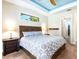 This bedroom features a decorative ceiling and accents; plenty of space and natural light for a tranquil retreat at 3215 Peace River Dr, Punta Gorda, FL 33983