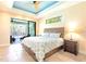 The bedroom is complete with a ceiling fan and access to a covered patio and pool area at 3215 Peace River Dr, Punta Gorda, FL 33983
