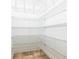 Walk-in closet with multiple white wire shelves and tile flooring for optimal organization at 3215 Peace River Dr, Punta Gorda, FL 33983