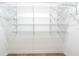 Walk-in closet with white walls and multiple, fully installed wire shelves for ample storage at 3215 Peace River Dr, Punta Gorda, FL 33983