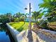 Dock with outdoor shower, tropical landscaping, and waterfront views create a serene outdoor oasis at 3215 Peace River Dr, Punta Gorda, FL 33983