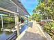 Dock with boat lift and a paver walkway lined with tropical foliage along the waterfront at 3215 Peace River Dr, Punta Gorda, FL 33983