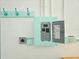 A close-up of the turquoise electrical panel with matching outlet covers and triple hooks at 3215 Peace River Dr, Punta Gorda, FL 33983