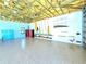 Large garage space with an open rafter ceiling, epoxy floor, surfboard racks, and blue trim accents at 3215 Peace River Dr, Punta Gorda, FL 33983