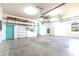 Spacious three car garage with high ceilings, shelving, and dual access doors at 3215 Peace River Dr, Punta Gorda, FL 33983