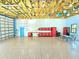 Spacious garage includes an open rafter ceiling, epoxy floor, and red tool cabinets for organized storage and workspace at 3215 Peace River Dr, Punta Gorda, FL 33983