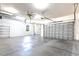 Large three-car garage with ceiling fan, high ceilings and concrete floors at 3215 Peace River Dr, Punta Gorda, FL 33983
