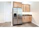 Kitchen with wooden cabinets and stainless steel refrigerator, perfect for modern living and efficient meal preparation at 3215 Peace River Dr, Punta Gorda, FL 33983