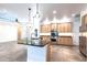 A spacious kitchen boasts an island with a black countertop, stainless steel appliances, and wooden cabinets at 3215 Peace River Dr, Punta Gorda, FL 33983