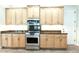 The kitchen features stainless steel appliances, light wood cabinets and dark countertop at 3215 Peace River Dr, Punta Gorda, FL 33983