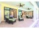 Covered lanai featuring comfortable seating and ceiling fans with views of the interior at 3215 Peace River Dr, Punta Gorda, FL 33983