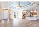 Open-concept living area with tile flooring, a tray ceiling, and seamless flow to the kitchen at 3215 Peace River Dr, Punta Gorda, FL 33983