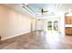 Spacious living area with tile flooring, a tray ceiling, and abundant natural light at 3215 Peace River Dr, Punta Gorda, FL 33983