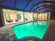 Inviting pool with brick surround and screened enclosure offers seamless indoor-outdoor living at 3215 Peace River Dr, Punta Gorda, FL 33983