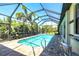 Sparkling screened-in pool surrounded by lush landscaping with a relaxing backyard oasis at 3215 Peace River Dr, Punta Gorda, FL 33983