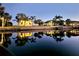 Stunning waterfront home with serene water views and reflections at twilight at 3215 Peace River Dr, Punta Gorda, FL 33983