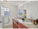 Bathroom with a double sink vanity, granite countertop, and a large mirror at 3803 Pin Oaks St, Sarasota, FL 34232