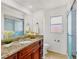 Clean bathroom featuring granite counters, modern fixtures, and a glass-enclosed shower at 3803 Pin Oaks St, Sarasota, FL 34232