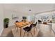 Spacious dining area with modern decor, seamlessly flowing into the inviting living room at 3803 Pin Oaks St, Sarasota, FL 34232