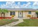 Charming single-story home featuring a well-manicured lawn and inviting front entrance at 3803 Pin Oaks St, Sarasota, FL 34232