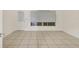 A clean living room featuring light flooring, bright walls, and two windows at 3803 Pin Oaks St, Sarasota, FL 34232