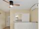 Bright living room featuring a ceiling fan, modern air conditioning, and an entry to the bathroom at 3803 Pin Oaks St, Sarasota, FL 34232
