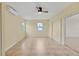 A sunny living room features a modern fan, light walls, and light flooring at 3803 Pin Oaks St, Sarasota, FL 34232