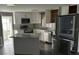 Modern kitchen features stainless appliances, white cabinets and an island at 125 Dolphin S Dr, Oldsmar, FL 34677