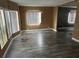 Bright living room features a wall of windows and lovely vinyl floors at 125 Dolphin S Dr, Oldsmar, FL 34677