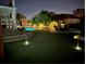 Extensive backyard complete with a pool, putting green, and outdoor seating under festive lighting at 5900 Leeland S St, St Petersburg, FL 33715