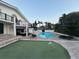 A luxurious backyard featuring a swimming pool, lounge area, mini golf course, and outdoor seating at 5900 Leeland S St, St Petersburg, FL 33715
