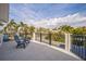 Second story balcony with seating, perfect for enjoying the views of the mature, palm tree filled neighborhood at 5900 Leeland S St, St Petersburg, FL 33715