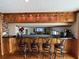 Charming bar area with wood cabinets, granite countertop, wood flooring, and bar stool seating at 5900 Leeland S St, St Petersburg, FL 33715