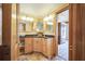 Well-lit bathroom features a wood cabinet, granite countertop, and double mirrors at 5900 Leeland S St, St Petersburg, FL 33715