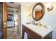 Bathroom with a dark wood vanity, light countertop, and decorative fixtures at 5900 Leeland S St, St Petersburg, FL 33715