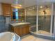 Well-appointed bathroom featuring blue tiling, vanity with a soaking tub, and glass-enclosed shower at 5900 Leeland S St, St Petersburg, FL 33715