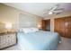Serene bedroom featuring an ornate headboard, ceiling fan, and closet space at 5900 Leeland S St, St Petersburg, FL 33715