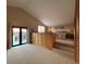 Spacious bedroom with built-in dresser, plush carpeting, and access to a balcony at 5900 Leeland S St, St Petersburg, FL 33715
