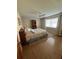 Cozy bedroom with hardwood floors, ceiling fan, and window with natural light at 5900 Leeland S St, St Petersburg, FL 33715