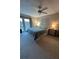 Bedroom with ceiling fan, decorative headboard and side tables, and private balcony access at 5900 Leeland S St, St Petersburg, FL 33715