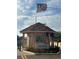 Bayway Isles community gate with an American flag, showcasing a secure and welcoming entrance at 5900 Leeland S St, St Petersburg, FL 33715