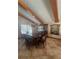 Elegant dining room featuring wooden beamed ceilings, a large dining table, and stylish furnishings at 5900 Leeland S St, St Petersburg, FL 33715