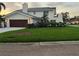 Home displaying a manicured lawn, a well maintained garage and architectural charm at 5900 Leeland S St, St Petersburg, FL 33715
