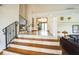 Open foyer with wood and tile staircase, and views into the bar area and living room at 5900 Leeland S St, St Petersburg, FL 33715