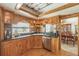 Charming kitchen with wooden cabinets, granite countertops and a stainless steel dishwasher at 5900 Leeland S St, St Petersburg, FL 33715